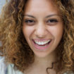 Young woman with curly hair laughing